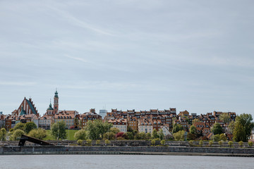 Fototapeta premium City over the river. Warsaw over the Vistula. The old town is the Polish and Viennese Boulevards. Old and owen parts of the city. Architecture. Temples and churches. High-rise buildings and historic