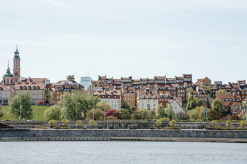 Obraz premium City over the river. Warsaw over the Vistula. The old town is the Polish and Viennese Boulevards. Old and owen parts of the city. Architecture. Temples and churches. High-rise buildings and historic