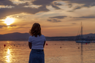 Beautiful sad girl in the sunset