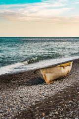 Lonely boat on the sunset beach