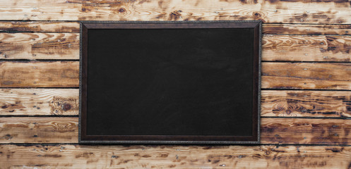Blackboard on wooden background with space for text,black elegant frame 