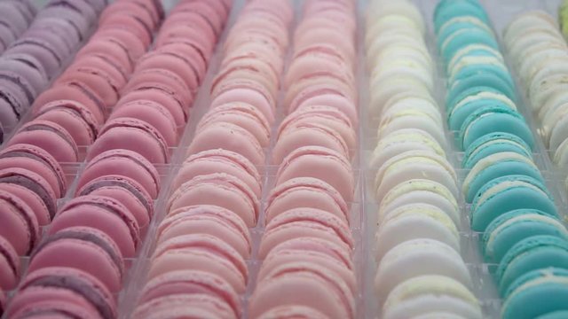 Macarons slide in slow motion inside a bakery