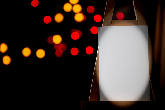 Staffli with copy space and blurred colorful lights in the background