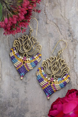 Macrame brass earrings on natural background