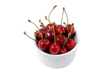 Cherry in a bowl on a white background. View from above.