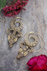 Macrame brass earrings on natural background