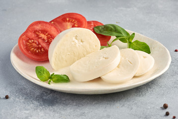 Mozzarella Buffalo with basil leaves and tomatoes.