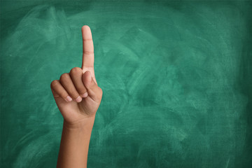 Student raising his hand for answer in classroom