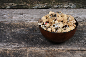Unclean peanuts in a plate. Front view.