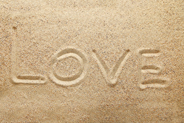 Inscription Love on beach sand