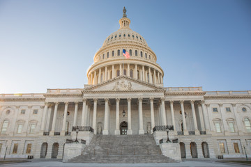 Wide view of the front of the US Capitol Building in Washington, DC without any people and a bright...