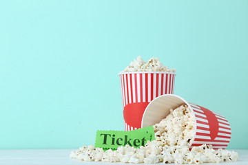 Popcorn in striped buckets on mint background