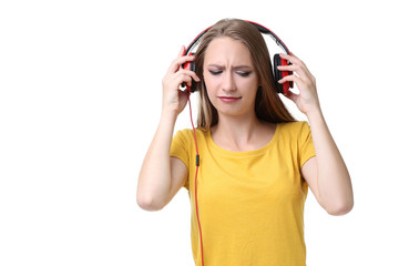 Young woman with headphones on white background