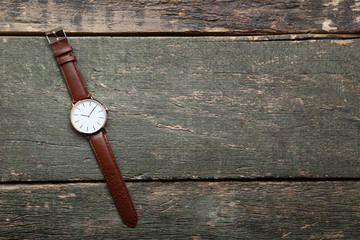 Wrist watch on grey wooden table