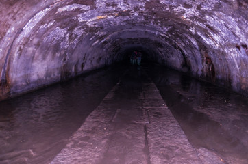 Semicircular tunnel under the ground. The dark tunnel.