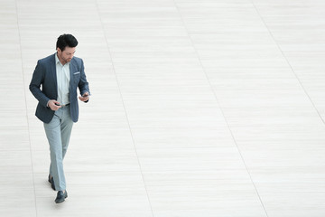 view from afar.businessman looks at the screen of the smartphone
