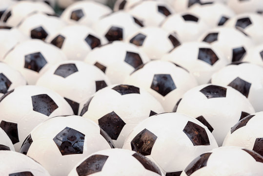 Group of wet soccer football balls full background.