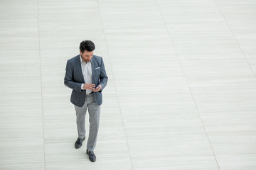 businessman dialing the number on the smartphone