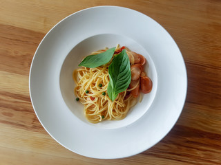 Spaghetti in white dish on the table background.