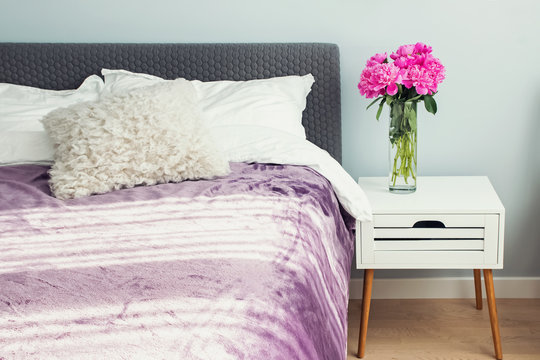 Bedroom With Peonies On The Nightstand At The Morning.