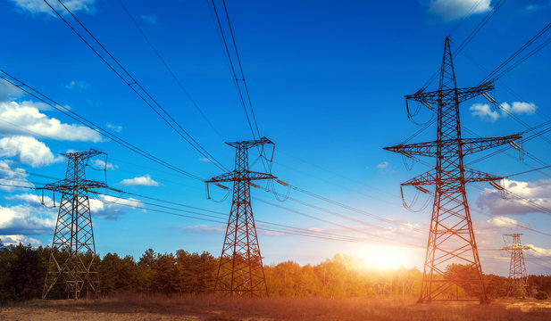  high-voltage  power lines at sunset.