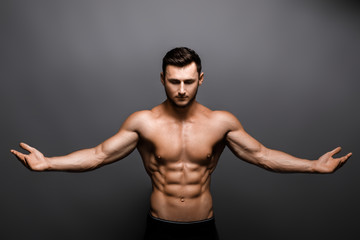 Fototapeta na wymiar Young handsome muscular man bodybuilder posing in the studio