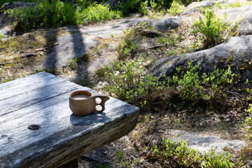 Wooden coffee mug on table; coffee break in nature in Suomussalmi, Finland.
