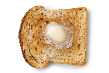 A single slice of whole wheat toast with a knob of melting butter isolated on white from above. - obrazy, fototapety, plakaty