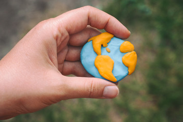 Woman holding planet Earth in her hand