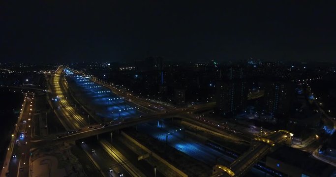 The highway in the big city, expressway enter the city, night light picture by drone on top view.