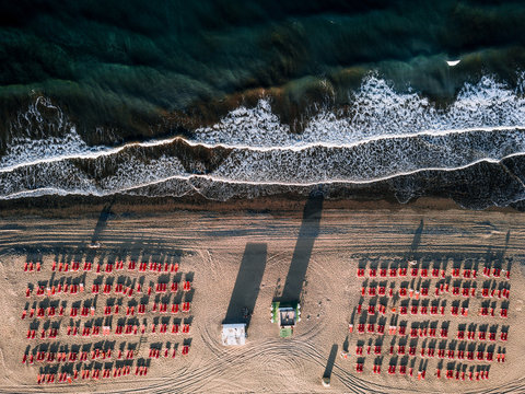 Aerial View Of Red Deck Chairs On Beach