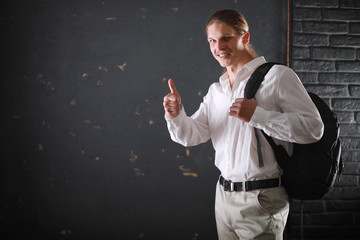 Student with long hair and a backpack with books