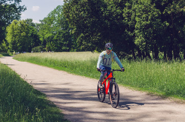 The cyclist in motion riding bicycle road