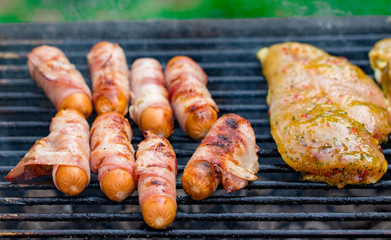 Assorted mixed grill from chicken meat, and pork, sausages  roasting on barbecue grid cooked for summer family dinner