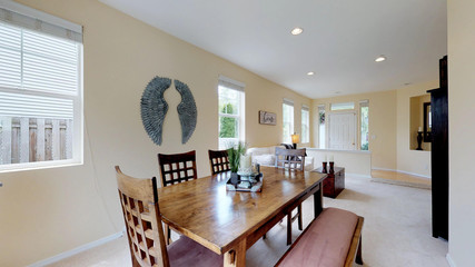 Bright open dining area with wooden table.