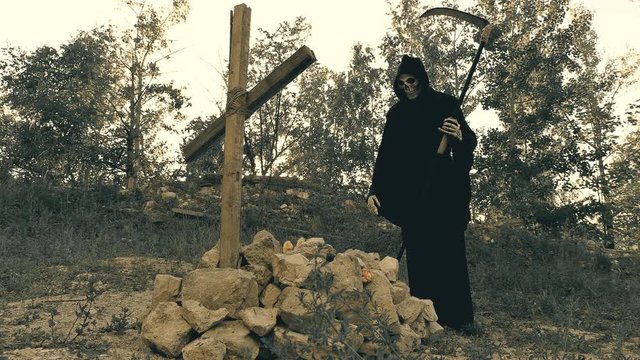 the grim Reaper throws flowers on the grave of another customer and gives a thumbs up ,which did a good job