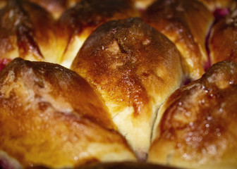 The baked domestic patties with cherries are coated by an egg