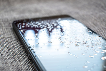 Raindrops on the glass. Wet rainy day. The world is reflected in the drops. The rain got the phone...