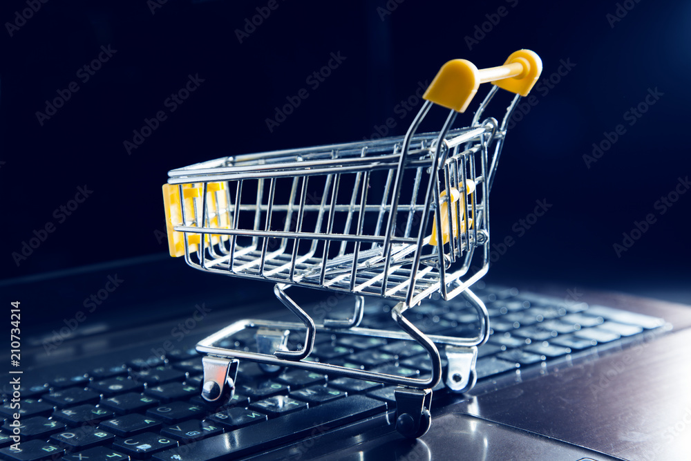 Poster internet shopping concept - basket on computer keyboard