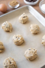 Overhead view on chocolate chip cookie dough balls on parchment paper