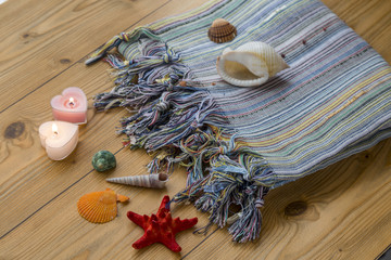 Turkish towel peshtemal with seashells, sea star, and candles