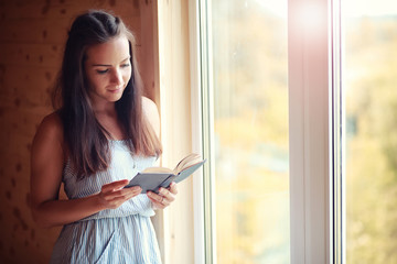 A girl at the window in the house