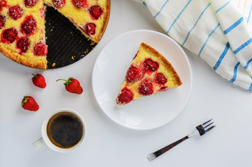 Slice of strawberry pie with a cup of tea on the table