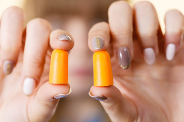 Woman holding protective earplugs