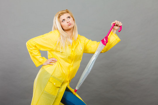 Thinking Woman Wearing Raincoat Holding Closed Umbrella