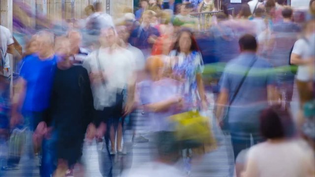 Crowd of blurry people moving on the station. Time lapse. Zoom out effect 