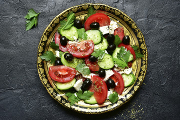 Vegetable salad with feta cheese - traditional dish of greek cuisine.Top view with copy space.