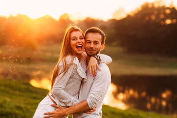 sincere emotions of a girl who hugs her boyfriend on the shore o