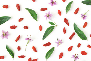 Closeup of Goji berries, Lycium barbarum. Dried Asian fruit, leaves and blossoms isolated on white...