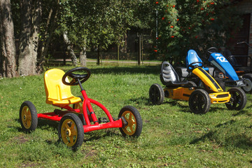 children pedal car awaiting riders at children park